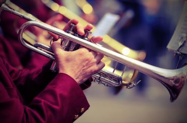 trumpeter plays his trumpet in the brass band during live event