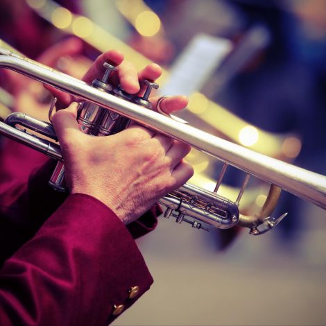 trumpeter plays his trumpet in the brass band during live event